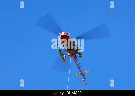 Swiss rescue helicopter in flight in the Swiss Alps, Switzerland Stock Photo