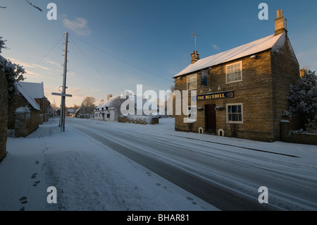 The Blue Bell Inn and John Clare Cottage in Helpston, near Peterborough, on cold winter day with a snow on the ground Stock Photo