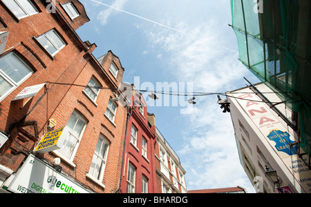 Pairs of shoes hanging from a telephone wire in Spitalfields, London Stock Photo