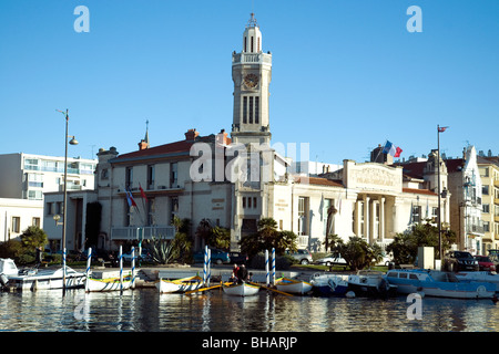 The Chamber of Commerce with its distinctive clocktower stands at a lunction of canals in Sète Stock Photo