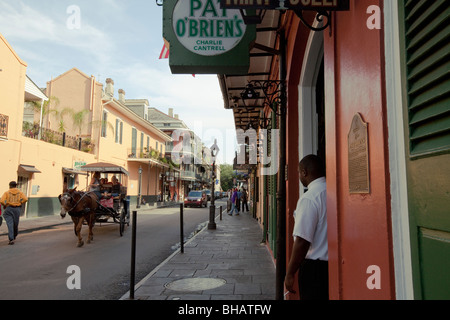 Horse-drawn carriage coming up St. Peter Street near Pat O'Brien's in French Quarter, New Orleans, Louisiana, USA. Stock Photo