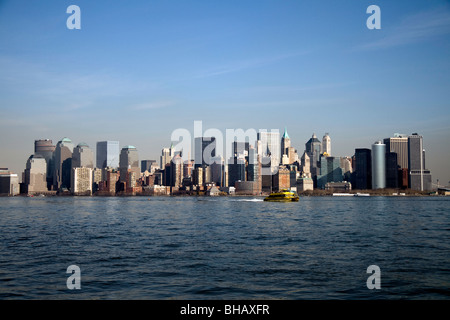 A water taxi speeds across the Hudson River with the downtown Manhattan skyline in the background Stock Photo