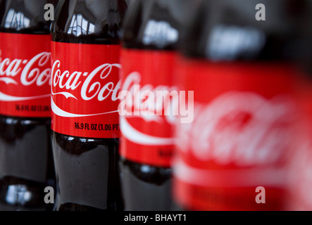 A grouping of Coca-Cola bottles.  Stock Photo