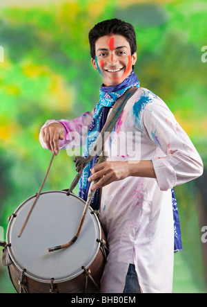 Man playing on a dhol Stock Photo