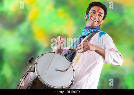 Man playing on a dhol Stock Photo