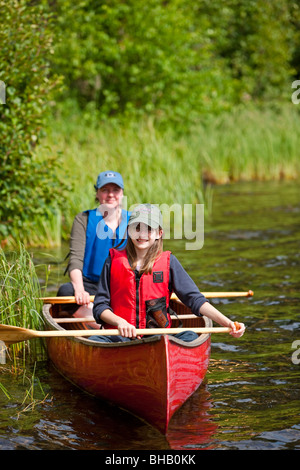 Mother and daughter paddling a canoe together on Byers Lake, Denali State Park, Southcentral Alaska, Summer Stock Photo