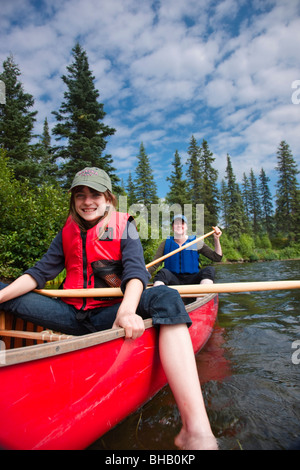 Mother and daughter paddling a canoe together on Byers Lake, Denali State Park, Southcentral Alaska, Summer Stock Photo