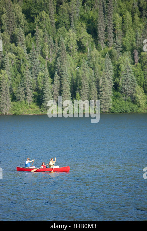 Family paddles a canoe together on Byers Lake, Summer, Denali State Park, Southcentral Alaska Stock Photo
