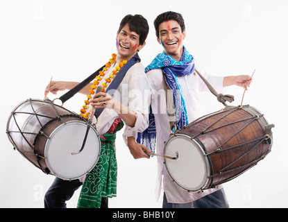 Two men playing on dholaks Stock Photo