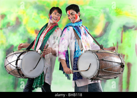 Two men playing on dhols Stock Photo