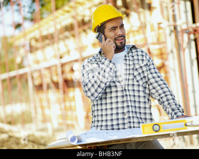 latin american construction worker talking on mobile phone. Copy space Stock Photo