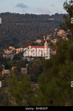 church of John the baptist baharim in the village of ein karem near Jerusalem seen from afar amongst trees with hills in bkgd Stock Photo