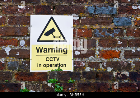 CCTV sign on a brick wall in a West Wycombe car park Buckinghamshire UK Stock Photo