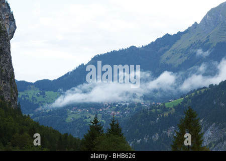 Town of Wengen in Clouds from Lauterbrunnen, Small Swiss Village in the Bernese Oberland Alps - Switzerland Stock Photo