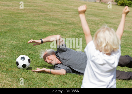 grandfather and child playing football Stock Photo