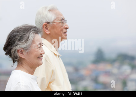 Japan, Tokyo Prefecture, Senior couple looking away, side view, close-up Stock Photo