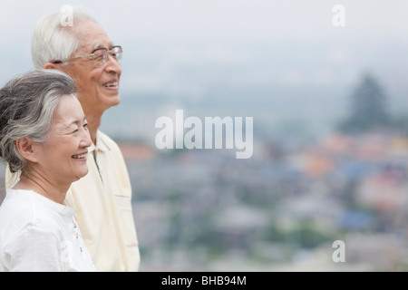 Japan, Tokyo Prefecture, Senior couple looking away, side view, close-up Stock Photo