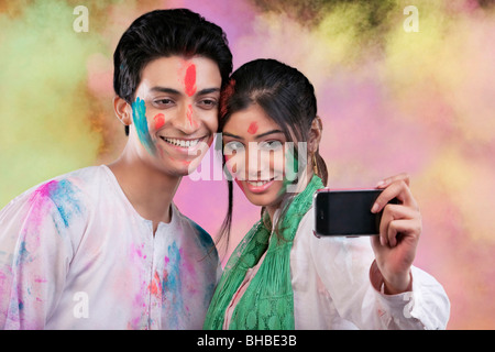 Couple taking a photograph of themselves Stock Photo
