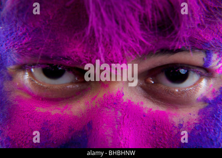 Man's face covered in holi colours Stock Photo