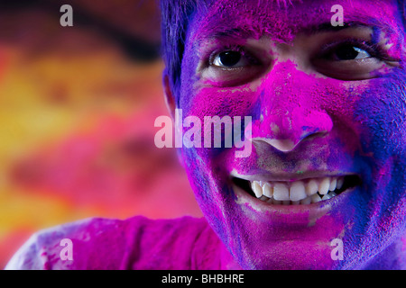 Man's face covered in holi colours Stock Photo