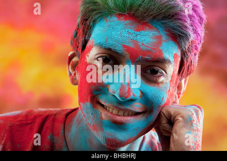 Man's face covered in holi colours Stock Photo