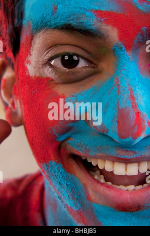 Man's face covered in holi colours Stock Photo