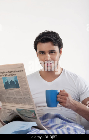 Man with a newspaper and coffee Stock Photo