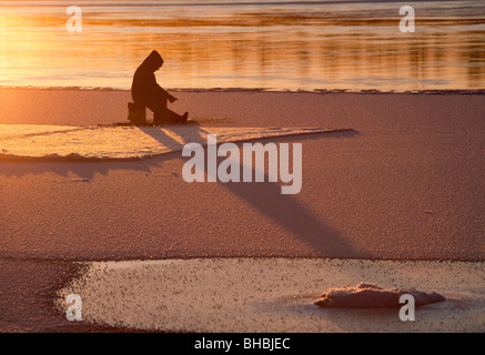 Ice-fishing at Oulujoki river Finland Stock Photo