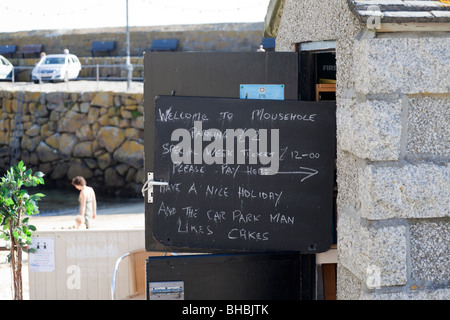 Notice on the car park attendant's hut on the harbourfront in the old fishing village of Mousehole, Cornwall Stock Photo