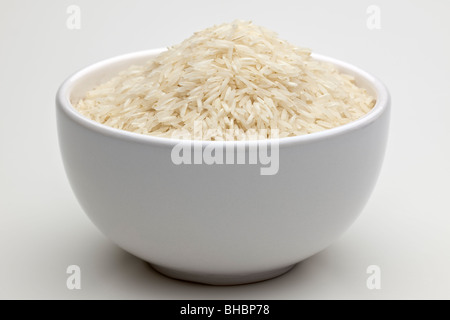 White bowl full of uncooked Basmati rice Stock Photo
