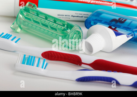 Toothpaste tooth paste tube with squeezer dispenser a toothbrush  personal oral hygiene products health dental care items horizontal in USA US hi-res Stock Photo