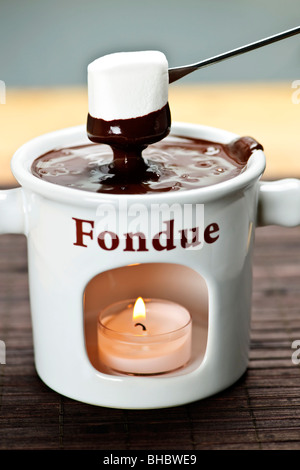 Marshmallow dipped in delicious melted chocolate fondue Stock Photo