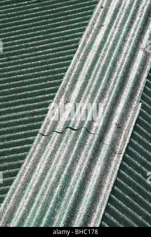 asbestos type sheets on property roof in sun Stock Photo