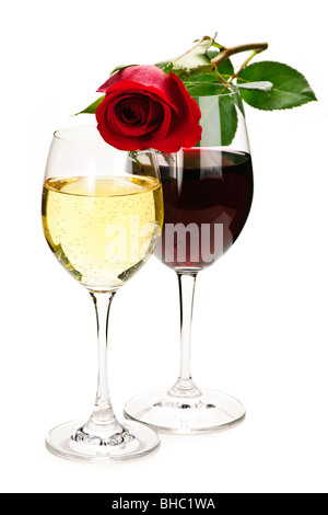 Romantic rose on top of red and white wine glasses isolated on white background Stock Photo