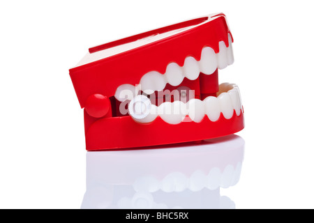 A pair of joke wind up chattering teeth on a pure white background, high resolution photo. Stock Photo