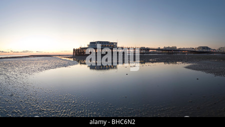 Worthing Pier stranded on the sand at low tide, Worthing, West Sussex, UK Stock Photo