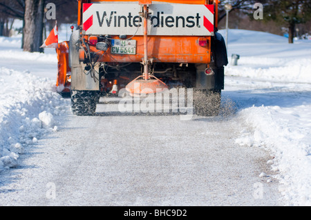 Road Gritter busy on the snow in Munich's Olympic park, Germany. Stock Photo