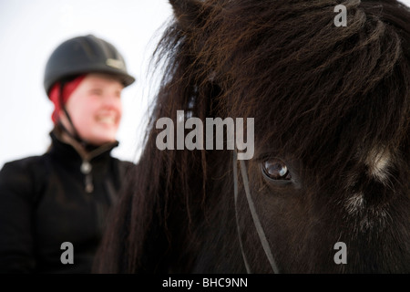 Woman smiling on horseback. Skagafjordur Iceland Stock Photo