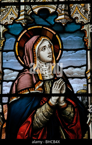 Detail from a stained glass window depicting The Blessed Virgin Mary at the Crucifixion, Over Silton Church, North Yorkshire Stock Photo