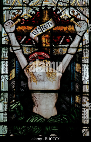 A stained glass window by C E Kempe, depicting The Crucifixion, St Wilfred's Church, Kirkby Knowle, North Yorkshire Stock Photo