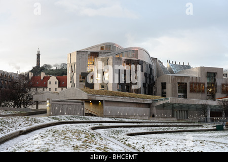 Scottish Parliament Building, Holyrood, Edinburgh, Scotland, UK, in the snow at dusk. Calton Hill is in the background. Stock Photo