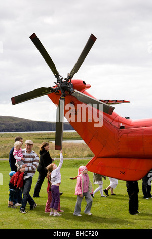 People gather around a helicopter from The Icelandic Coast Guard, Vogar in Vatnsleysustrond, Iceland. Stock Photo