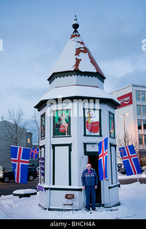 Man selling souvenirs to support Icelandic sports teams. Downtown Reykjavik, Southwest Iceland. Stock Photo