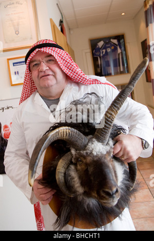 Man dressed-up as an oil baron on Ash Wednesday. He is holding a ram´s head Reykjavik Iceland Stock Photo