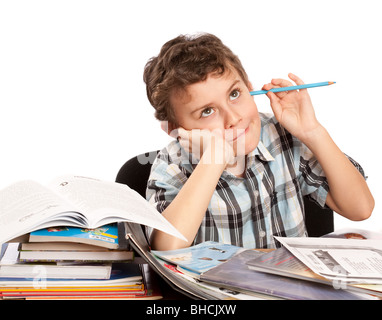 Portrait of a cute kid dreaming with his eyes open instead of doing his homework Stock Photo
