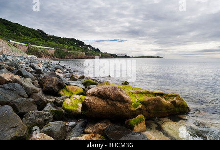 View northwards over Killiney Bay, Dublin, Ireland, from White Rock Beach, with Dublin DART train in the background Stock Photo