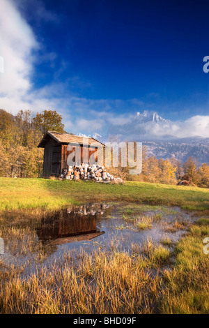 A hut beside a lake in Primiero valley underneath Pale di San Martino Stock Photo