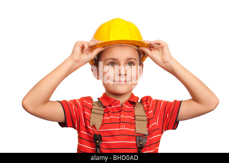 Cute kid putting on construction helmet, isolated on white background Stock Photo