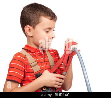 Little construction worker or plumber using pliers Stock Photo