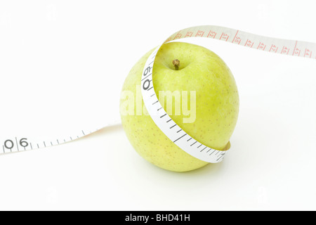 Tape measure wrapped around an apple Stock Photo